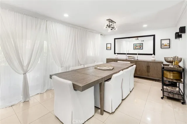 a kitchen that has a sink a table and chairs in it