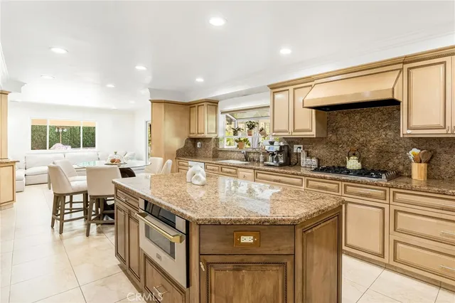 a kitchen with stainless steel appliances granite countertop a sink and cabinets