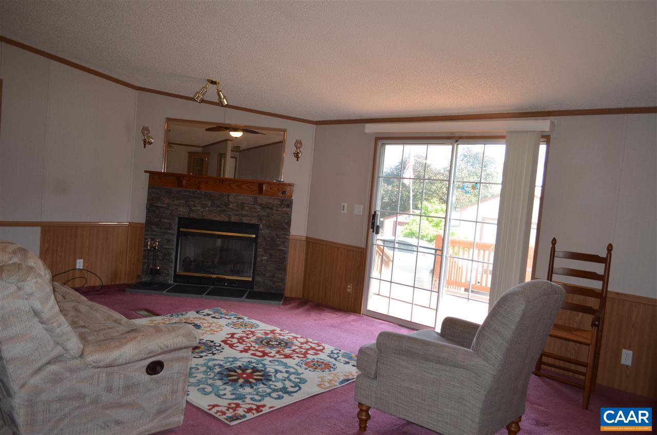 74 Begonia Road Ruckersville, VA 22968 - Photo 3 of 17 a living room with furniture and a fireplace