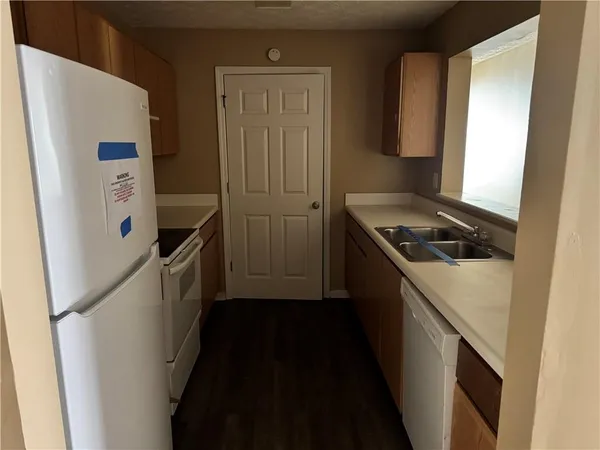 a kitchen with a refrigerator and a stove