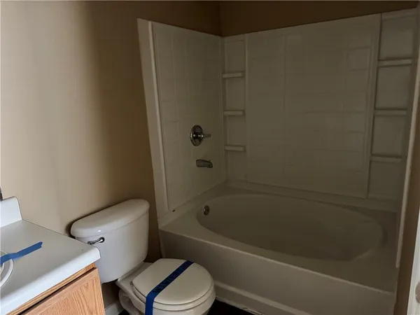a bathroom with a toilet and a bathtub