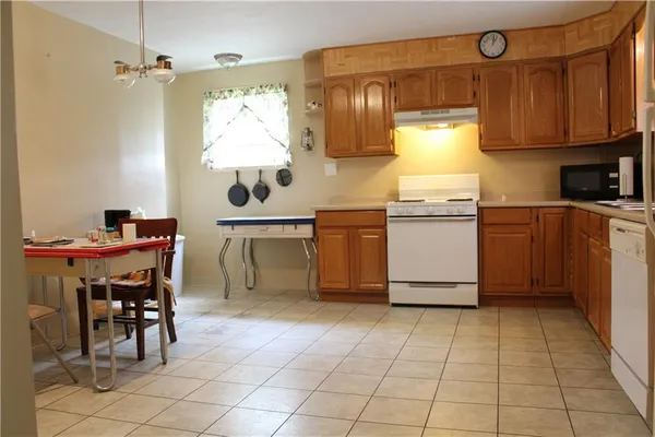 a kitchen with stainless steel appliances a stove a sink and a refrigerator