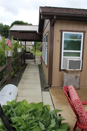 a backyard of a house with table and chairs