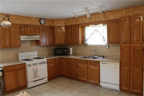 a kitchen with a stove window and cabinets