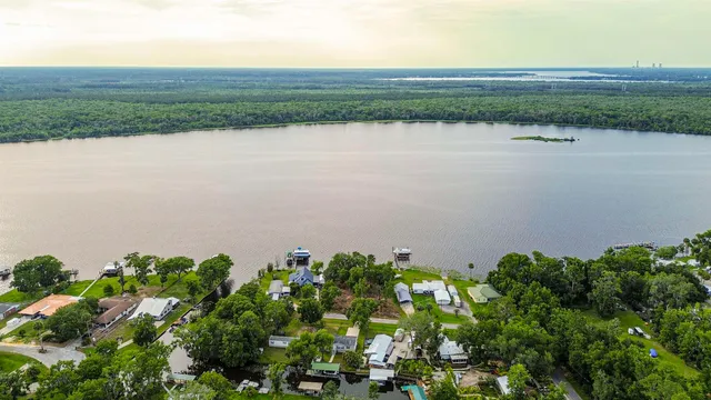 a view of a lake with a field