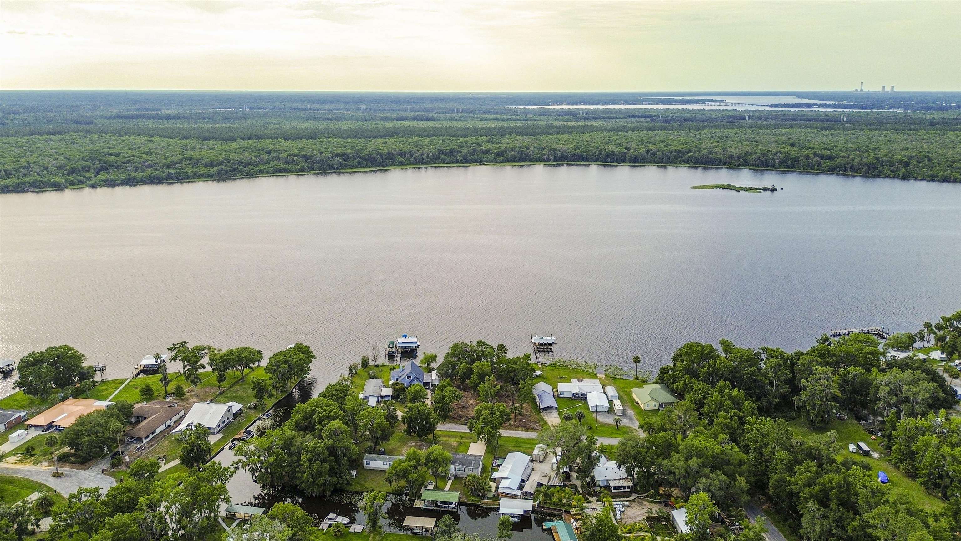 156 Rivershore Drive San Mateo, FL 32187 - Photo 7 of 9 a view of a lake with a field