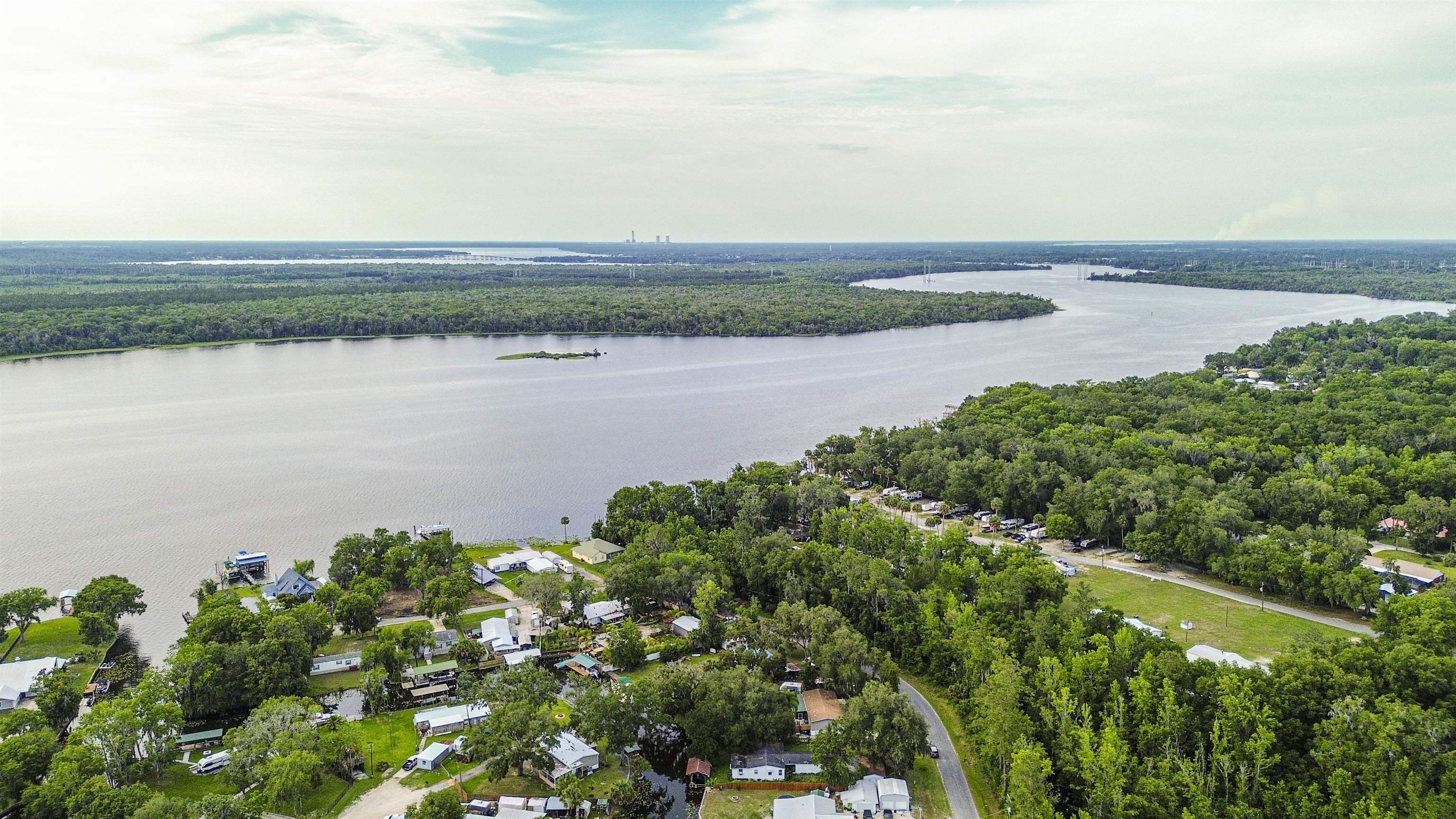 156 Rivershore Drive San Mateo, FL 32187 - Photo 8 of 9 a view of a lake with houses in the back