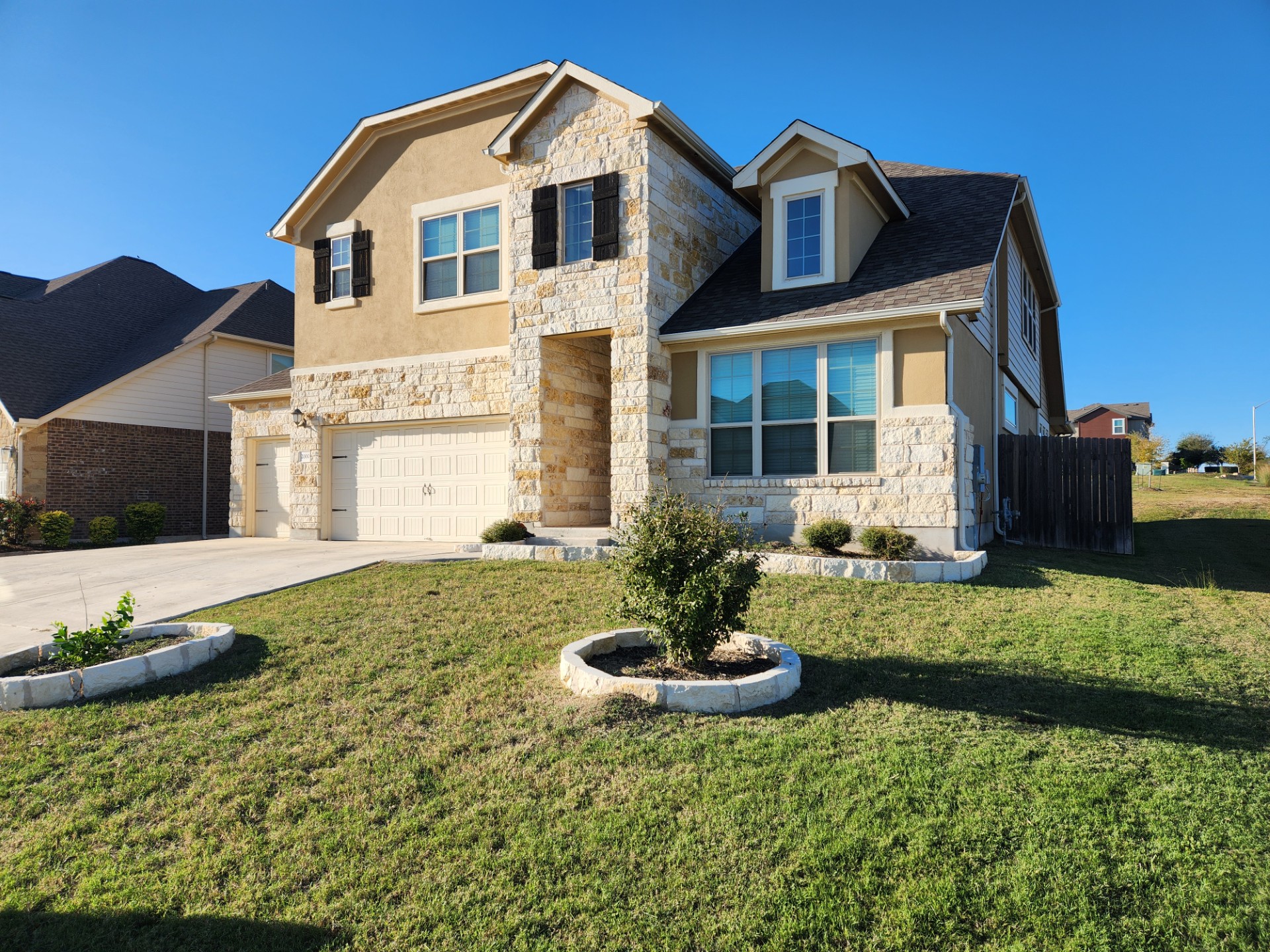2000 Chamberlin Trail Georgetown, TX 78626 - Photo 1 of 3 View of front facade featuring stone siding, driveway, an attached garage, and stucco siding