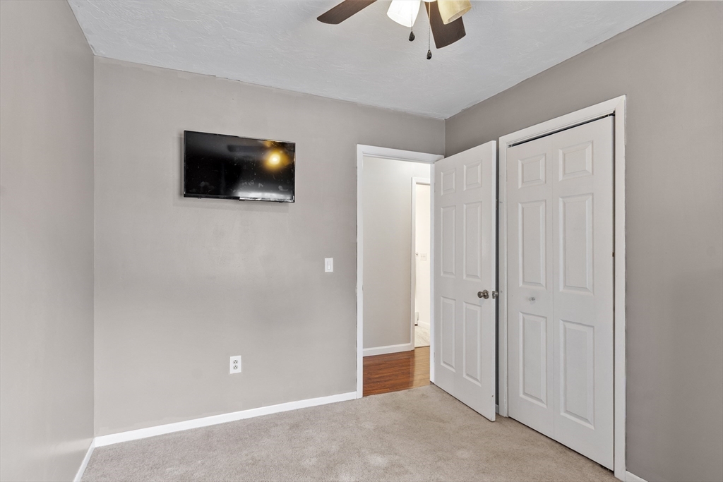 53 Laurel Hill Road Southbridge, MA 01550 - Photo 11 of 28 an empty room with a ceiling fan and a bathroom