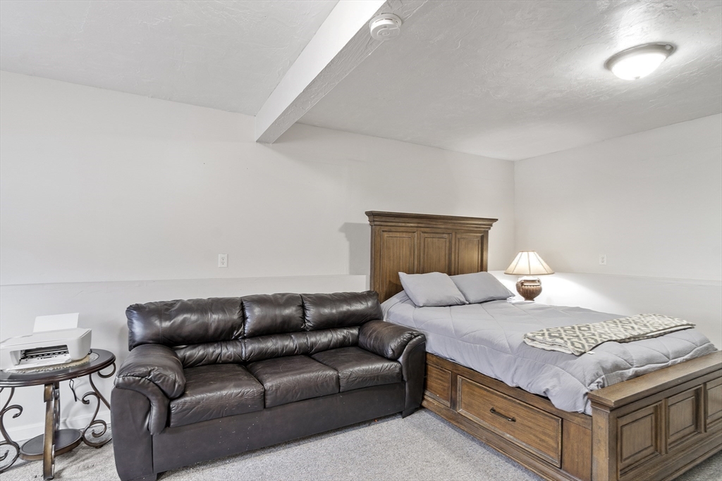 53 Laurel Hill Road Southbridge, MA 01550 - Photo 16 of 28 a bedroom with a bed and a couch