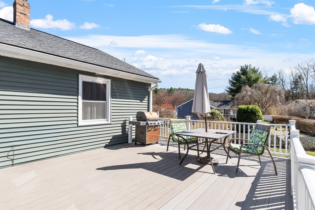 53 Laurel Hill Road Southbridge, MA 01550 - Photo 22 of 28 a view of a roof deck with table and chairs a barbeque with wooden floor and fence