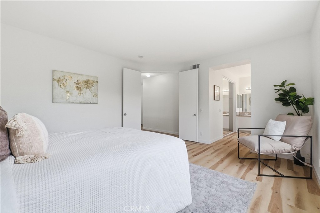 7522 Calais Court Rancho Cucamonga, CA 91730 - Photo 11 of 20 a spacious bedroom with a bed and a chair