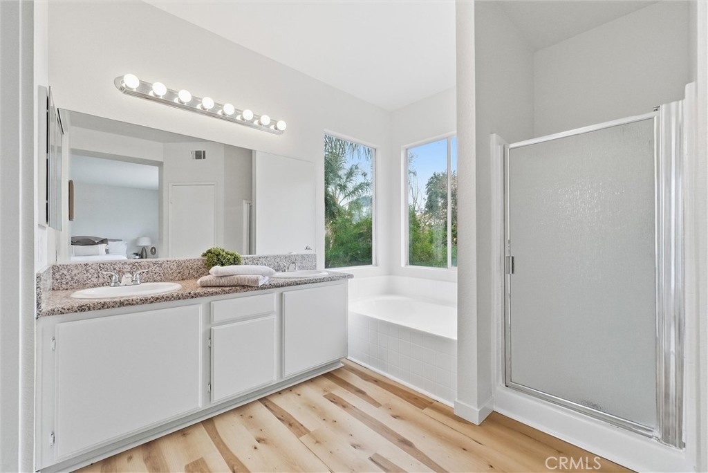 7522 Calais Court Rancho Cucamonga, CA 91730 - Photo 12 of 20 a bathroom with a granite countertop sink and a mirror