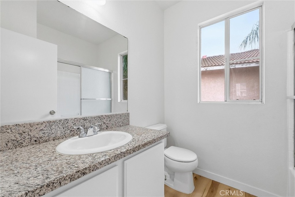 7522 Calais Court Rancho Cucamonga, CA 91730 - Photo 16 of 20 a bathroom with a granite countertop sink and a mirror