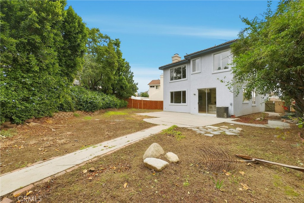 7522 Calais Court Rancho Cucamonga, CA 91730 - Photo 18 of 20 a view of a white house with a yard and large tree