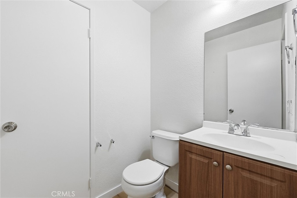 7522 Calais Court Rancho Cucamonga, CA 91730 - Photo 9 of 20 a bathroom with a sink a toilet and a mirror