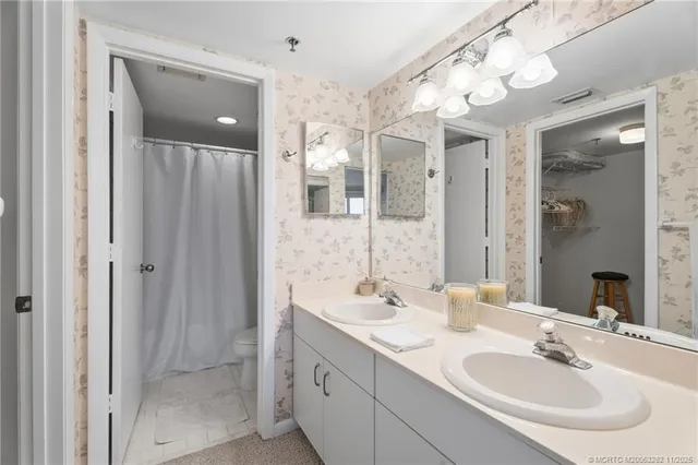 a bathroom with a sink double vanity and a mirror