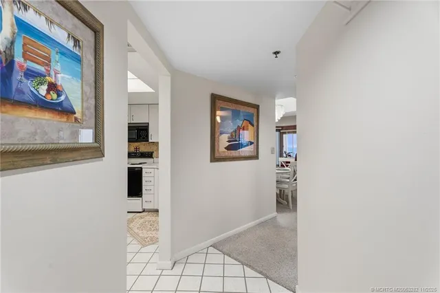a view of a hallway with wooden floor and furniture