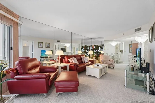 a living room with furniture and a chandelier