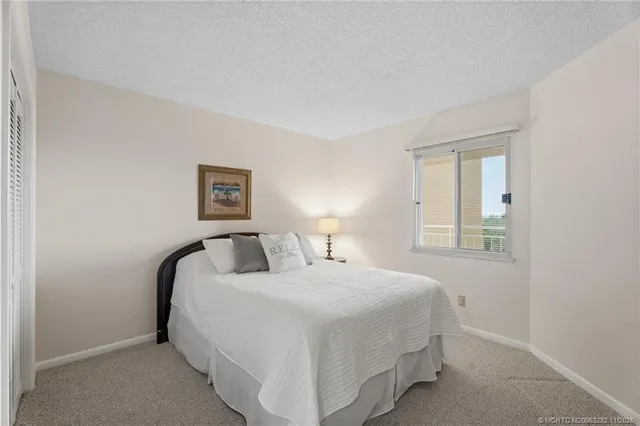 a bedroom with a bed and a mirror