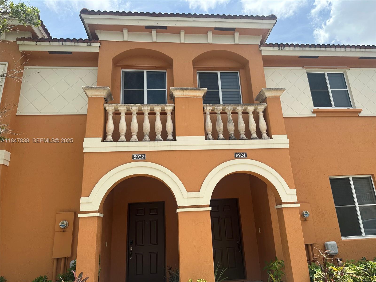 8922 Southwest 18th Street, Unit 8922 Miramar, FL 33025 - Photo 1 of 22 a view of a brick house with large windows