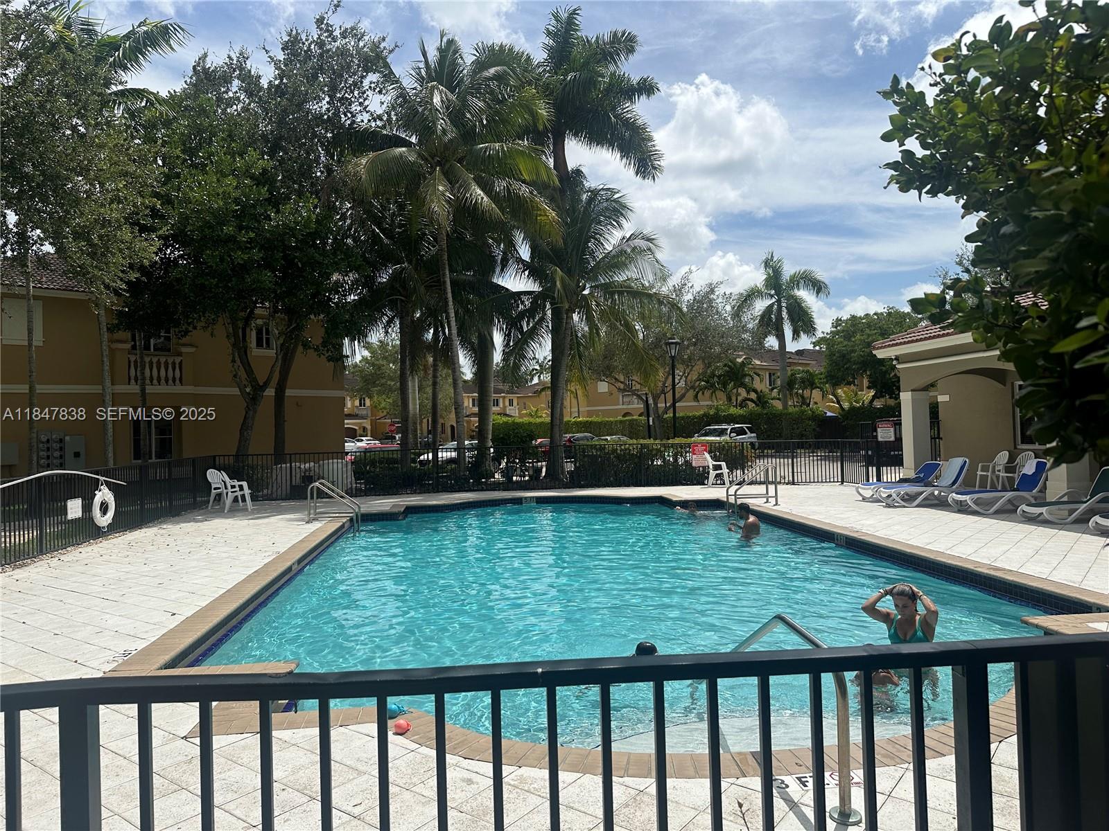 8922 Southwest 18th Street, Unit 8922 Miramar, FL 33025 - Photo 11 of 22 a view of swimming pool with lounge chair