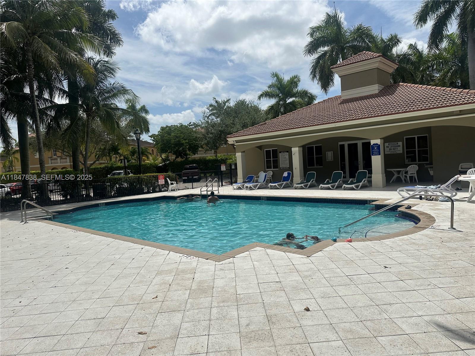 8922 Southwest 18th Street, Unit 8922 Miramar, FL 33025 - Photo 12 of 22 a view of a house with swimming pool and sitting area