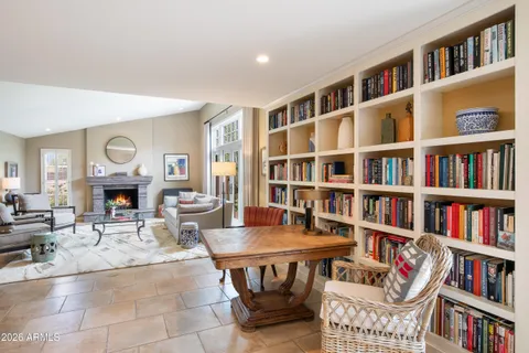 a living room with furniture and a book shelf