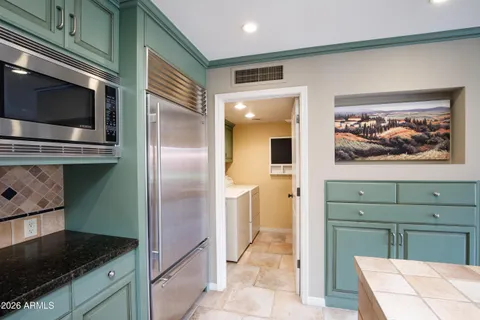 a kitchen with lots of counter top space sink and stainless steel appliances