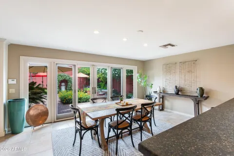 a view of a dining room with furniture large windows and wooden floor