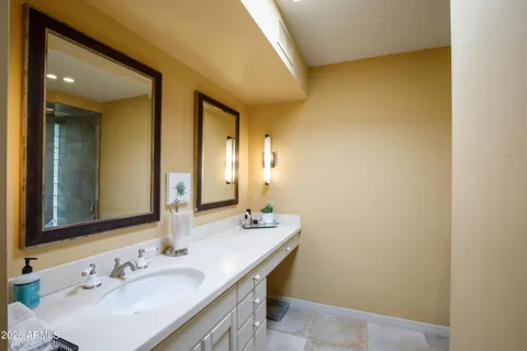 a bedroom with a bed and flat screen tv