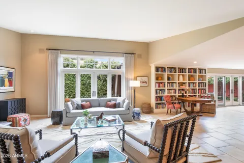a view of grassy field with benches and trees all around