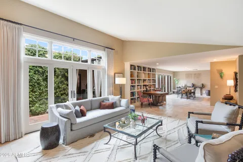 a living room with fireplace furniture and a large window