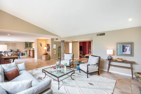 a living room with furniture and large windows