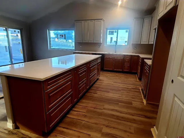 a kitchen with wooden floors and a sink