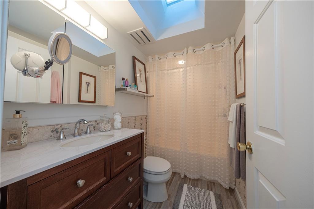 67 Ridge Road Pittsburgh, PA 15221 - Photo 14 of 37 a bathroom with a sink a toilet and mirror