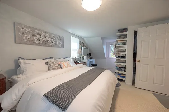 a bedroom with a bed and a book shelf