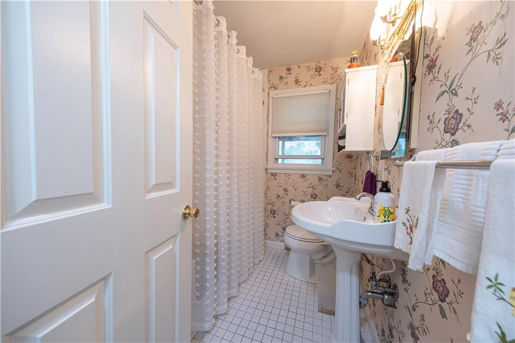 67 Ridge Road Pittsburgh, PA 15221 - Photo 5 of 37 a bathroom with a sink toilet and window