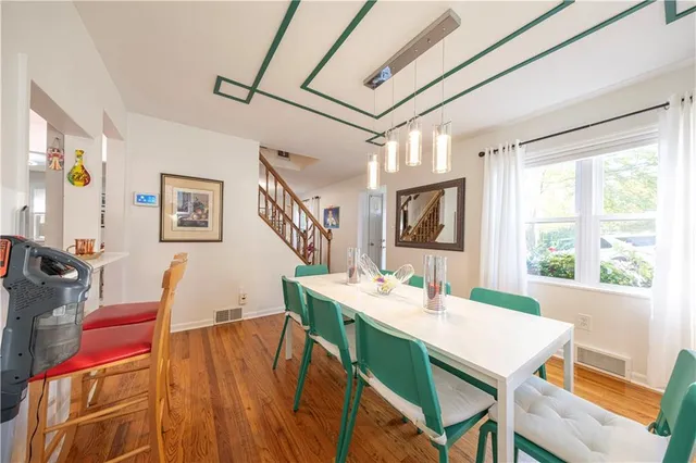 a view of a dining room with furniture window and wooden floor