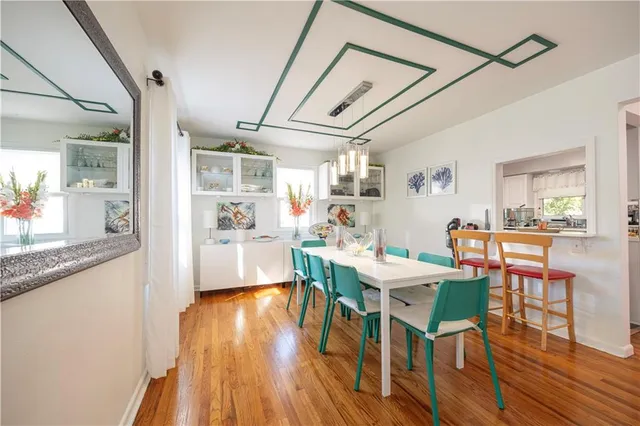 a view of a dining room with furniture wooden floor and a chandelier