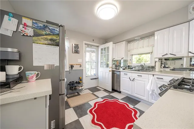 a kitchen with a sink cabinets and a window