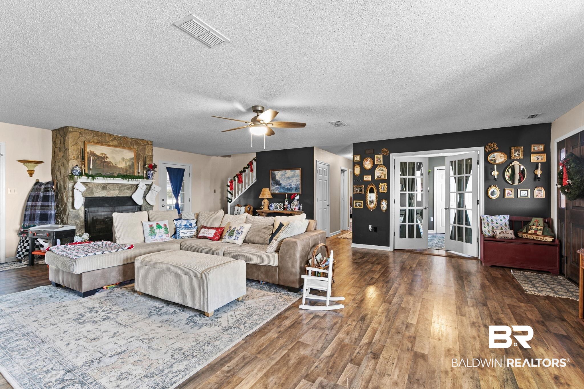 3842 Experiment Farm Road Monroeville, AL 36460 - Photo 16 of 59 Living area with a fireplace, dark wood finished floors, a textured ceiling, ceiling fan, and french doors