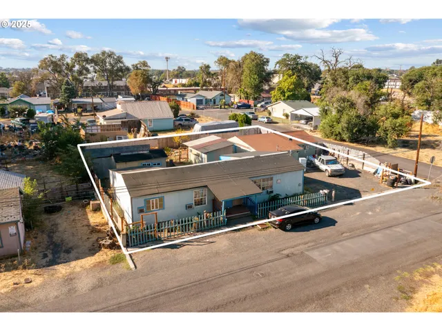 an aerial view of residential houses with outdoor space