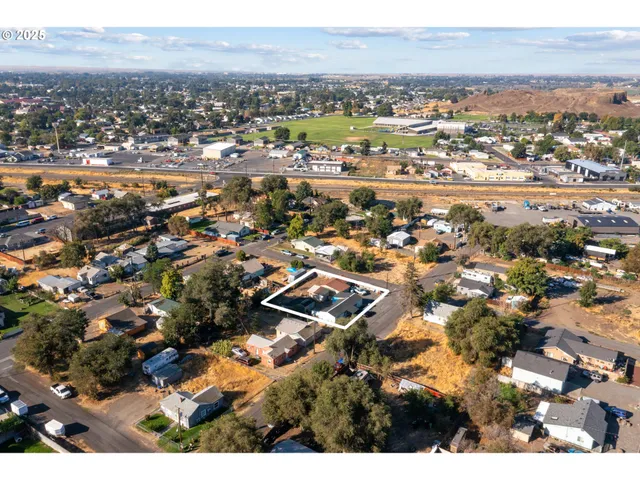 an aerial view of residential houses with city view