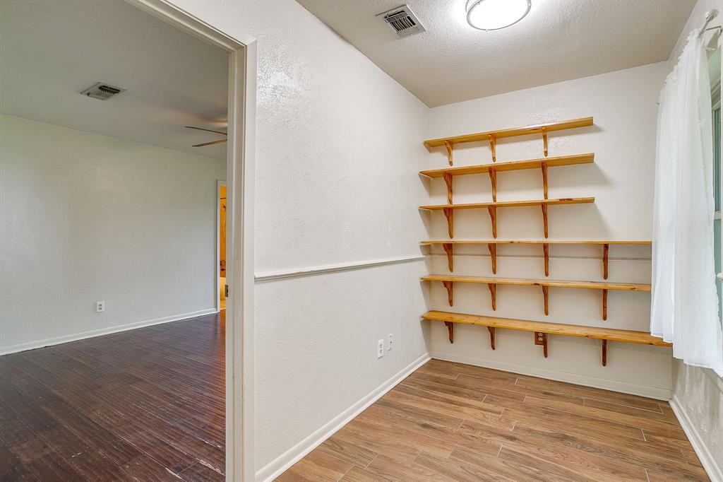 709 North Ave B Springtown, TX 76082 - Photo 21 of 32 a view of a room with wooden floor and shelf