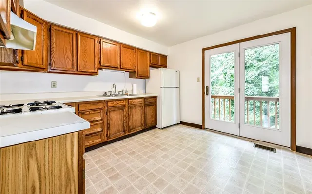 a view of a kitchen with electric appliances
