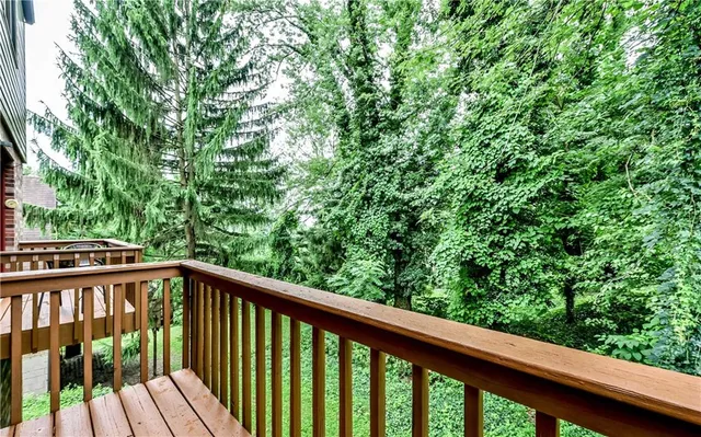 a view of a balcony with wooden floor