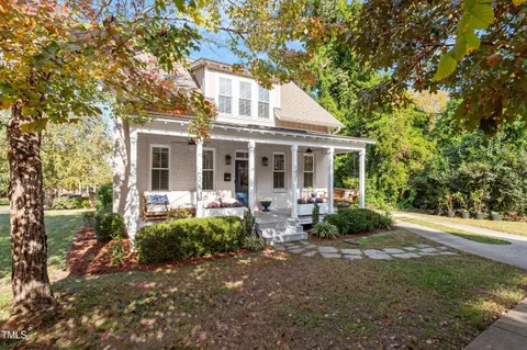 a front view of a house with garden and porch