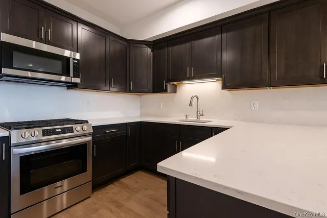 a kitchen with wooden cabinets and stainless steel appliances