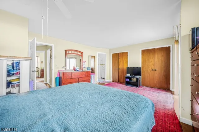 a bedroom with a large bed and a large closet